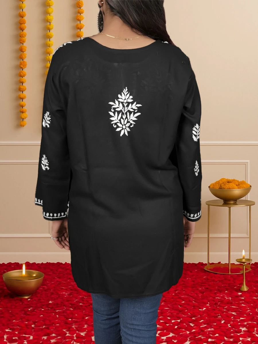 Model wearing black short Chikankari kurti with flared silhouette and detailed stitching