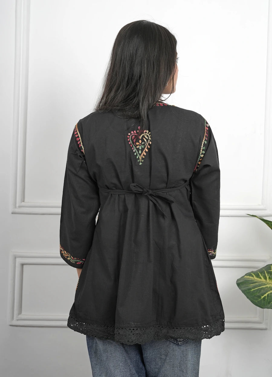 Black short kurti featuring detailed Chikankari thread work on neckline and sleeves