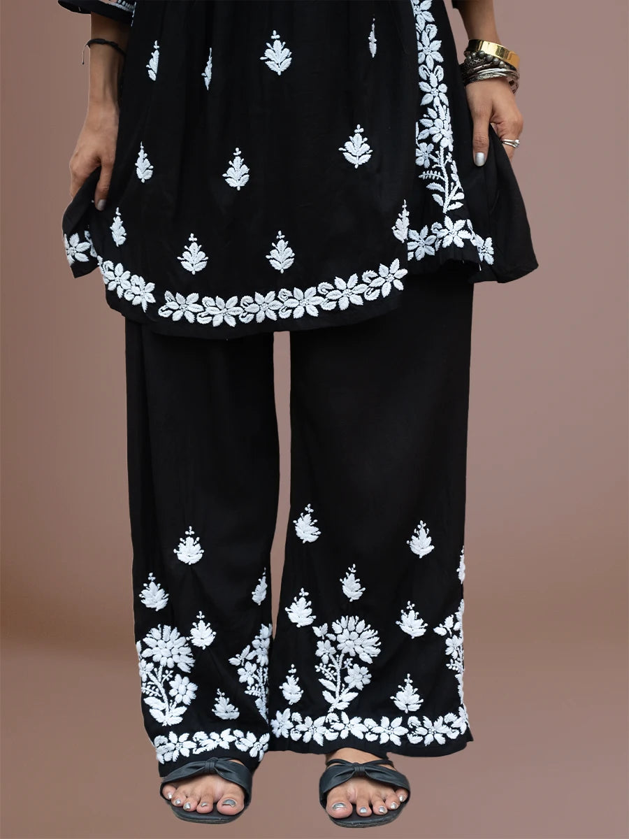 Model wearing flared rayon chikankari kurti with matching embroidered bottom