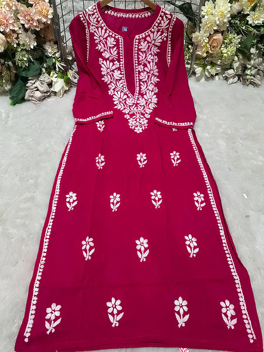 Vibrant rani red rayon kurti adorned with traditional white Chikankari gala booti work on the front panel.