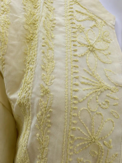 Close-up of intricate tone-on-tone Chikankari embroidery on yellow cotton kurti