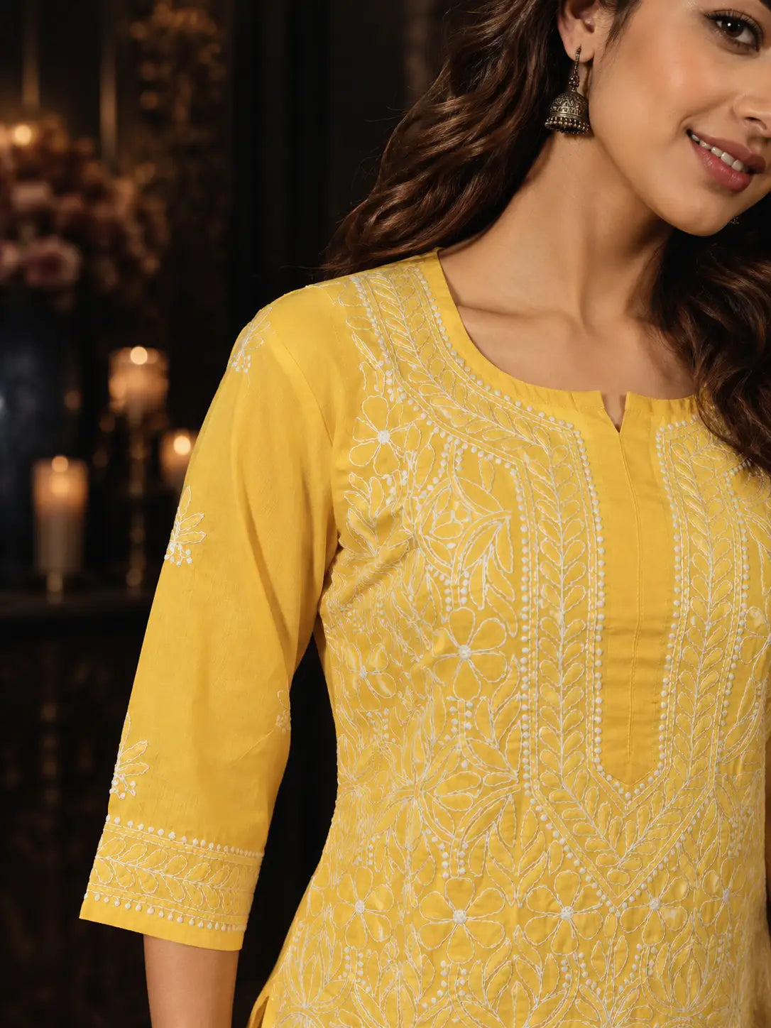 Deep yellow Chikankari kurti with intricate white embroidery