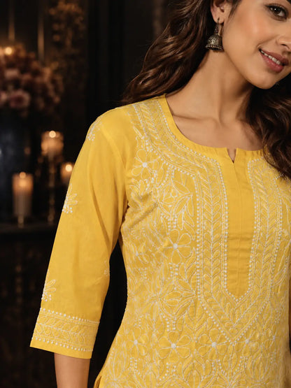 Deep yellow Chikankari kurti with intricate white embroidery