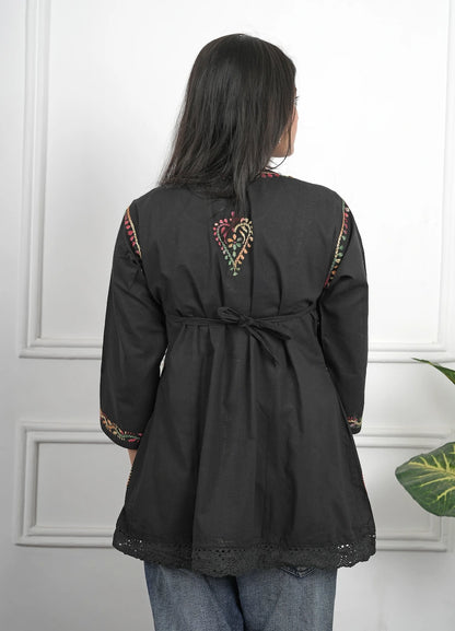 Black short kurti featuring detailed Chikankari thread work on neckline and sleeves

