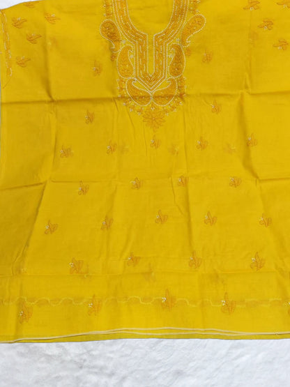 Bright yellow voile cotton dress material with delicate white shadow and fanda embroidery, ideal for haldi ceremonies and summer wear, displayed on a flat lay with elegant ethnic styling(Dniza Chikankari)