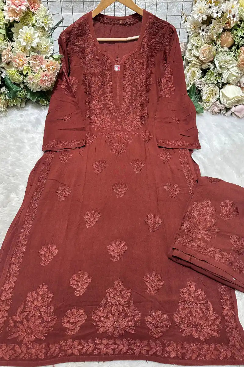 Front view of model in rosewood pink 3 boota rayon kurti with heavy neck embroidery and straight fit style