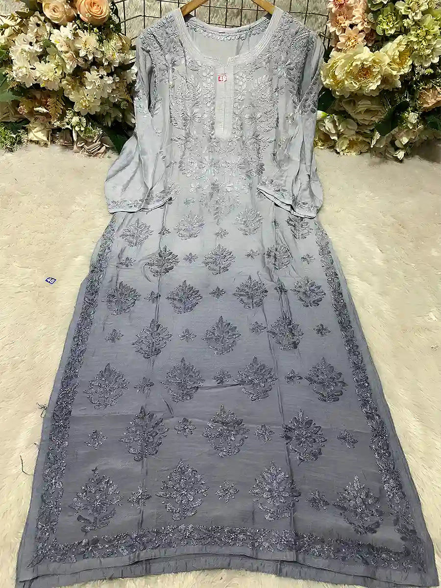 Grey masleen top featuring subtle embroidery and elegant monochrome detailing.

