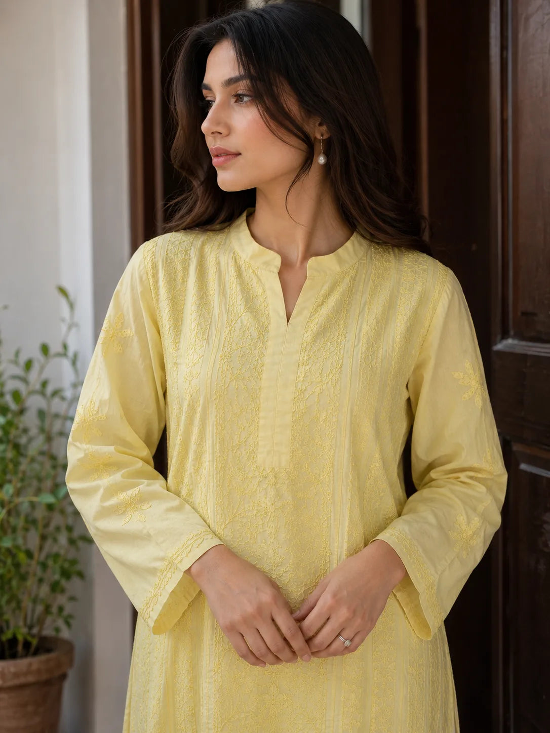 Handcrafted yellow cotton Chikankari kurti with embroidered sleeves and front panels