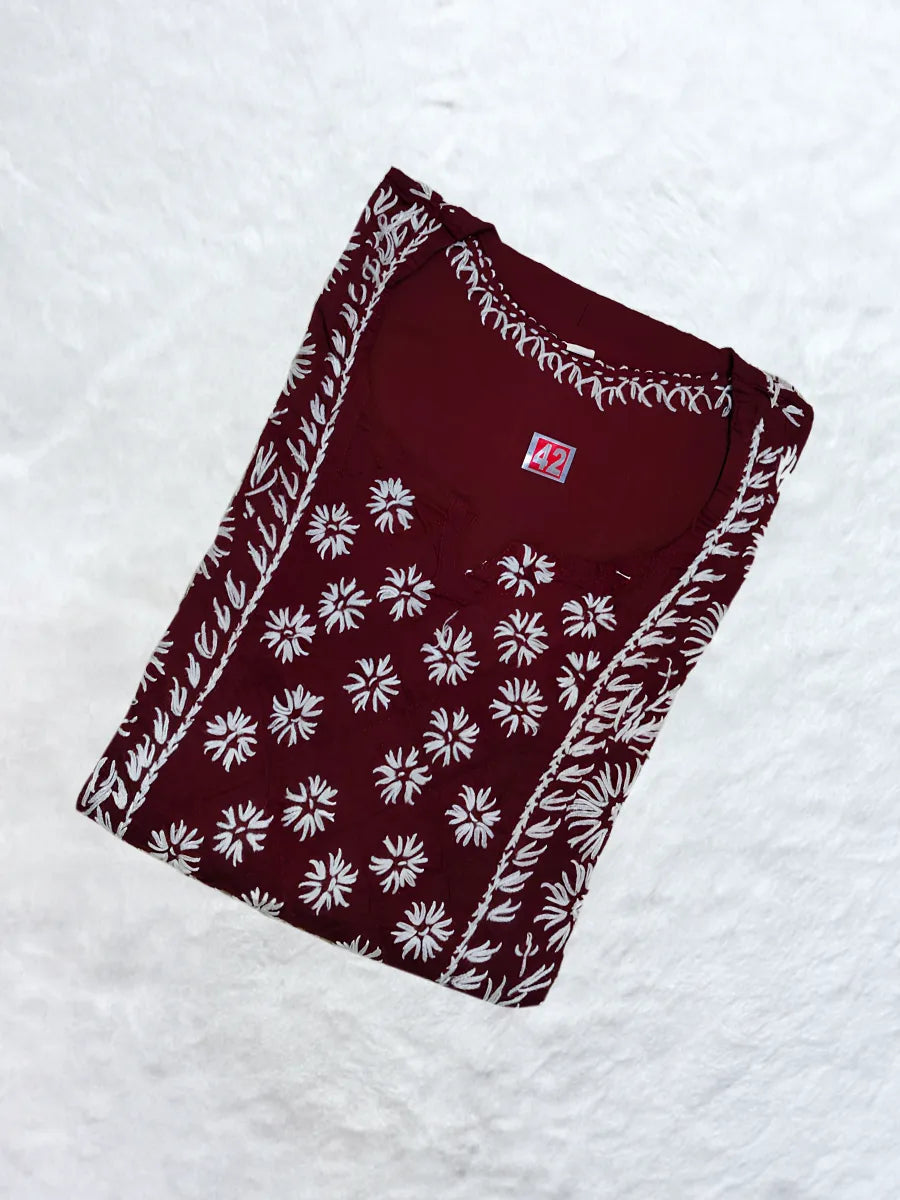 Maroon cotton kurti featuring white hand-embroidered gala booti and sleeve detailing

