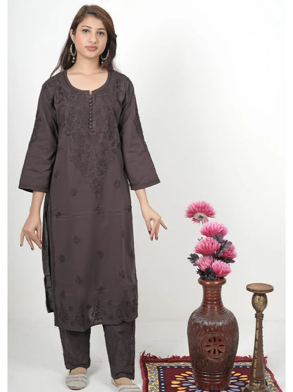 Model wearing deep cocoa brown mulmul chikankari kurti with matching embroidered pants