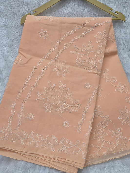 Peach blush cotton saree featuring delicate white floral shadow embroidery for a soft graceful appearance
