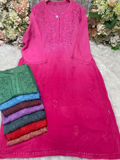 Stack of colorful embroidered ryon kurtis with detailed floral neck patterns and buttons