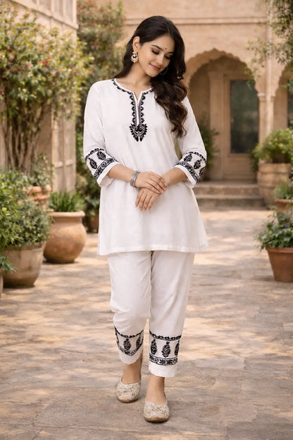 White chikankari embroidered co-ord set for women in soft rayon fabric, featuring a 38-inch kurti and matching pants with black thread embroidery, by Dniza Chikankari
