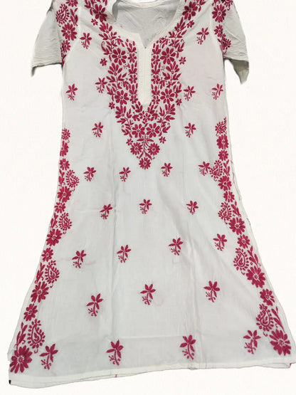 White mal cotton long kurti featuring intricate Ghaspatti embroidery in dark purple thread, neatly folded on a black backdrop – Dniza Chikankari.