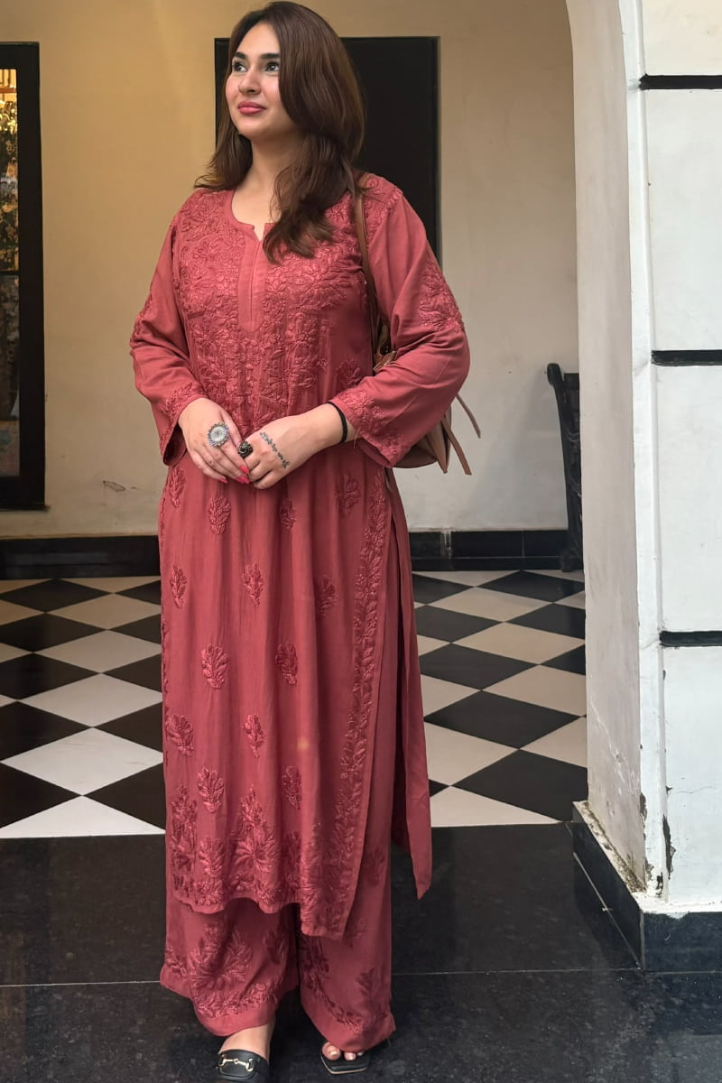 Woman wearing dusty rose pink embroidered rayon kurti set with fancy work and border design