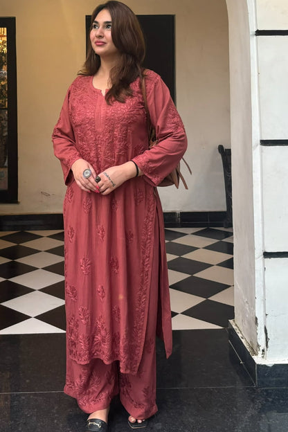 Woman wearing dusty rose pink embroidered rayon kurti set with fancy work and border design