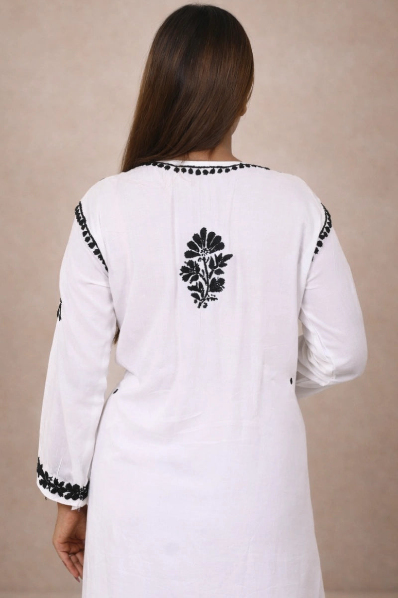 Women’s white and black embroidered kurti set with traditional floral patterns and straight fit design